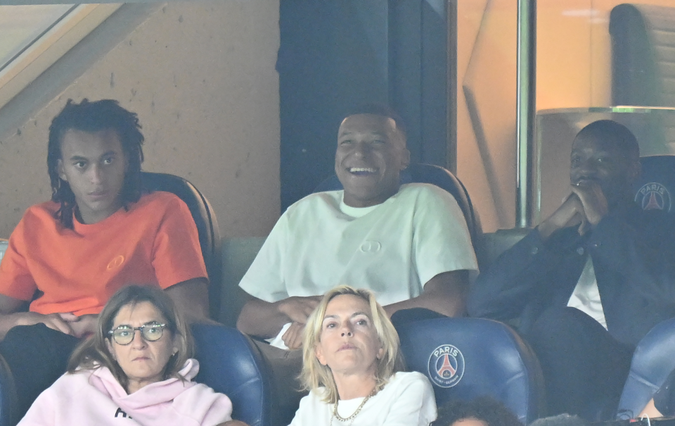 Kylian Mbappe all smiles as he joins Ousmane Dembele to watch Paris Saint-Germain struggle against Lorient in Ligue 1 opener